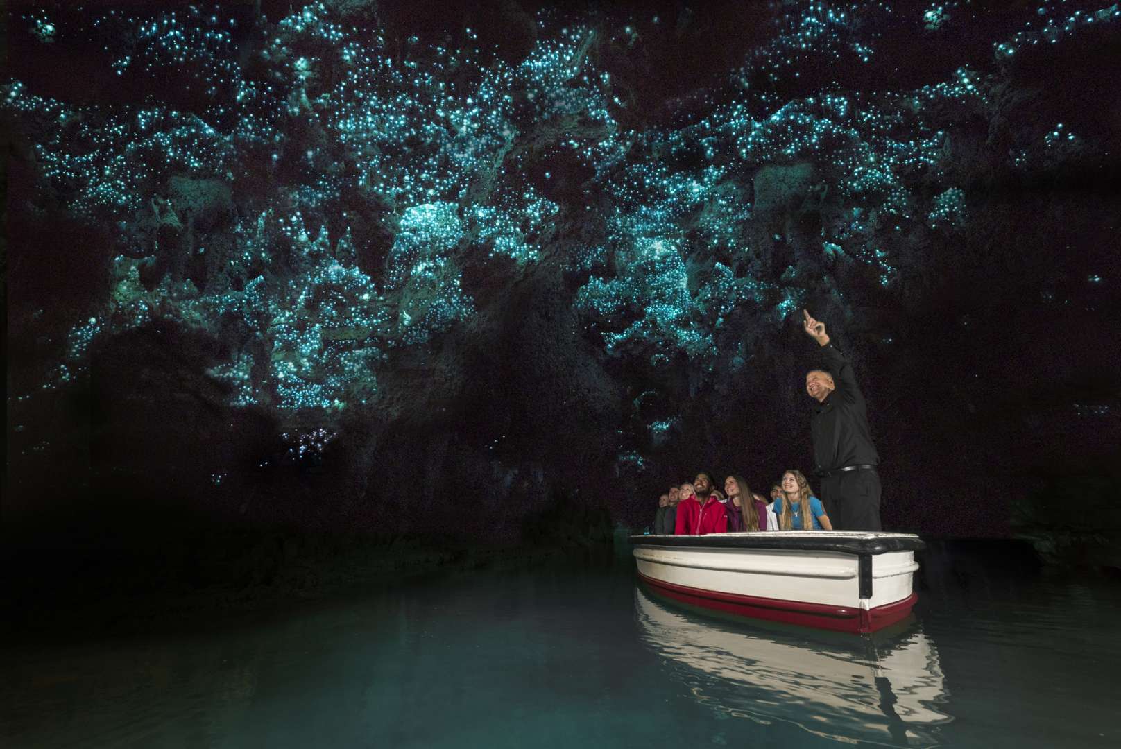 Boat ride under luminescent glowworms in the Waitomo River